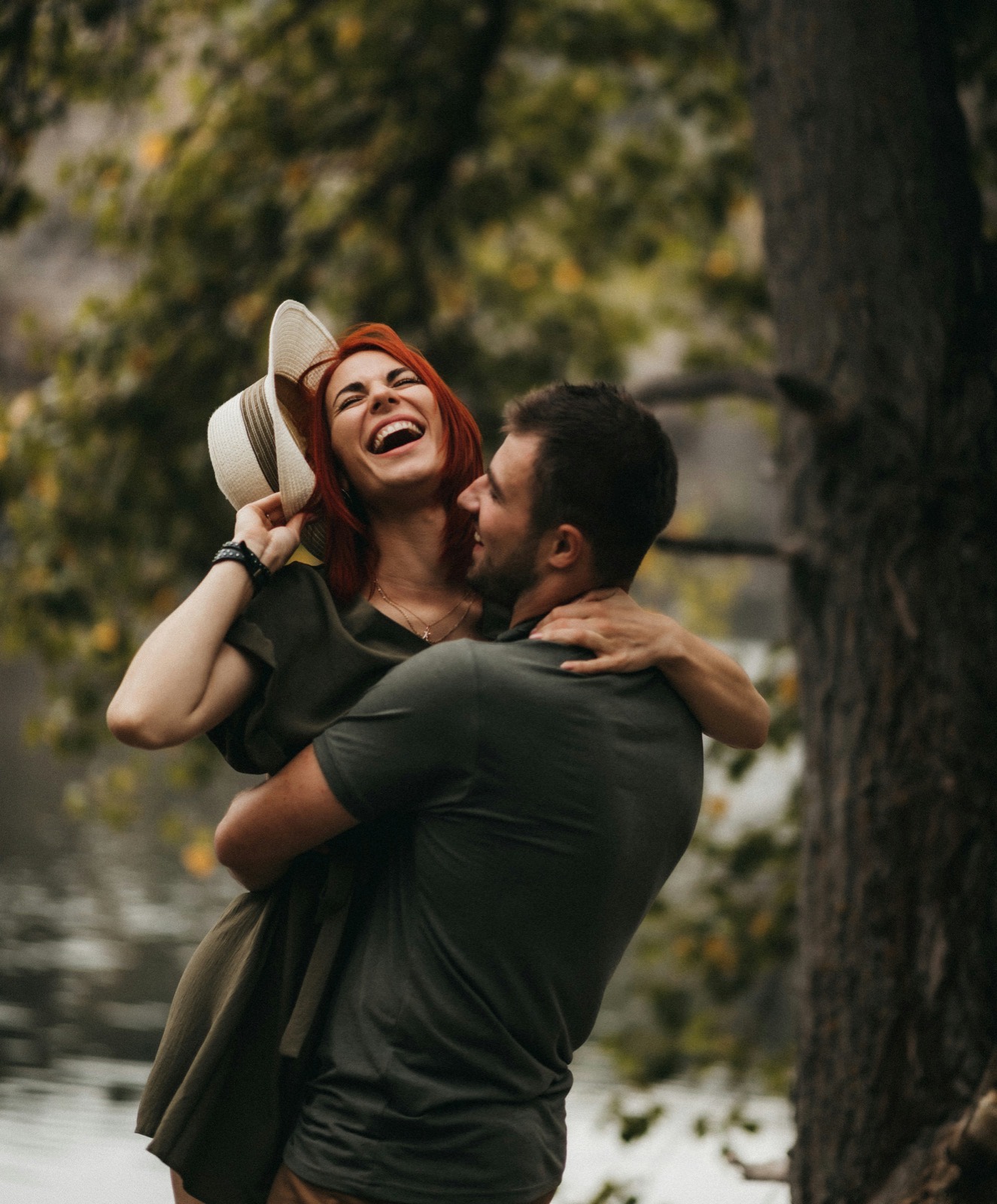 A couple laughing together outdoors